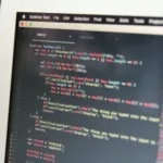 Close-up of code on a computer screen with Sublime Text editor in focus.