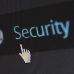 Close-up of a computer screen displaying the word 'Security' with a cursor icon pointing at it, indicating a digital security feature.