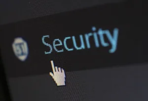 Close-up of a computer screen displaying the word 'Security' with a cursor icon pointing at it, indicating a digital security feature.